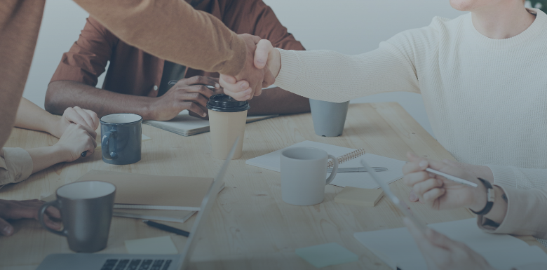 two people shaking hands during a meeting